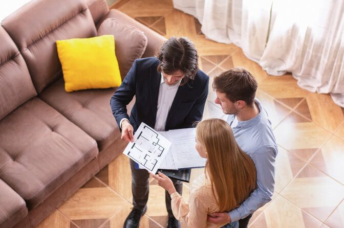 Letting agent showing a house plan